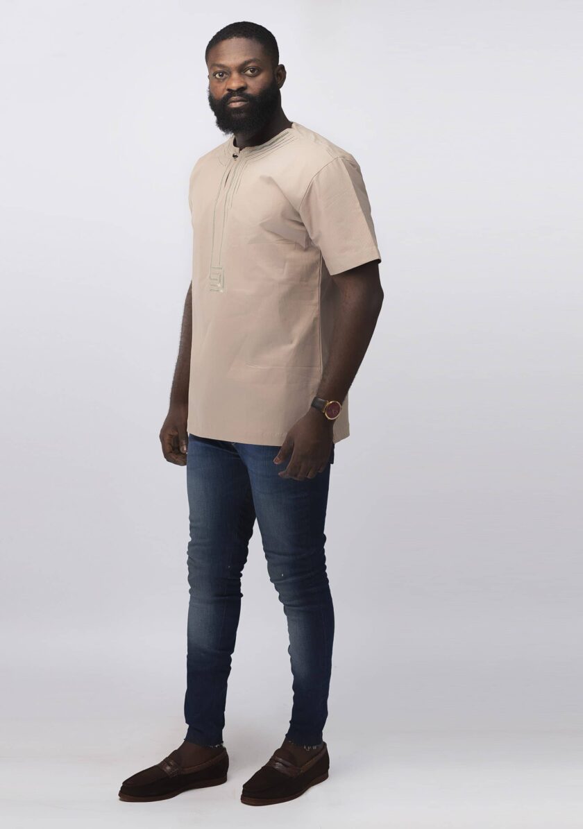 Frontal of model wearing our Modupe Slim Fit Embroidered African Shirt in beige.
