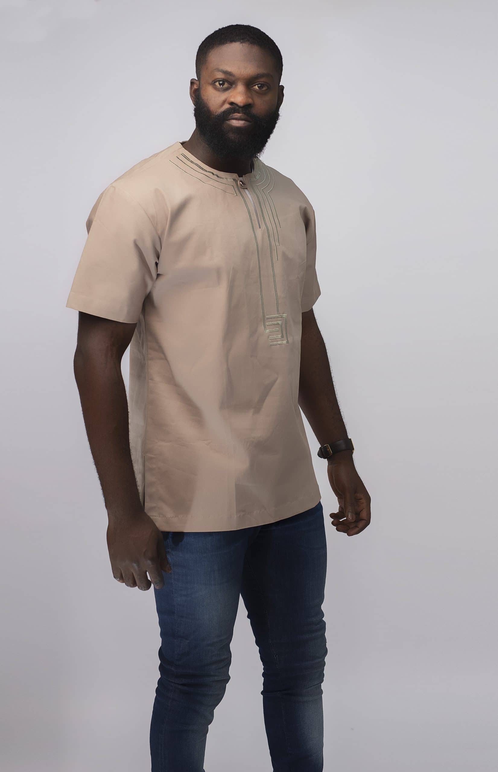 Frontal of model wearing our Modupe Slim Fit Embroidered African Shirt in beige.