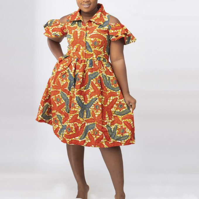 Frontal of model wearing our Oluchi skater midi dress in all over orange, gold and blue African print pattern. Features a cold shoulder, short sleeve, collar neckline.