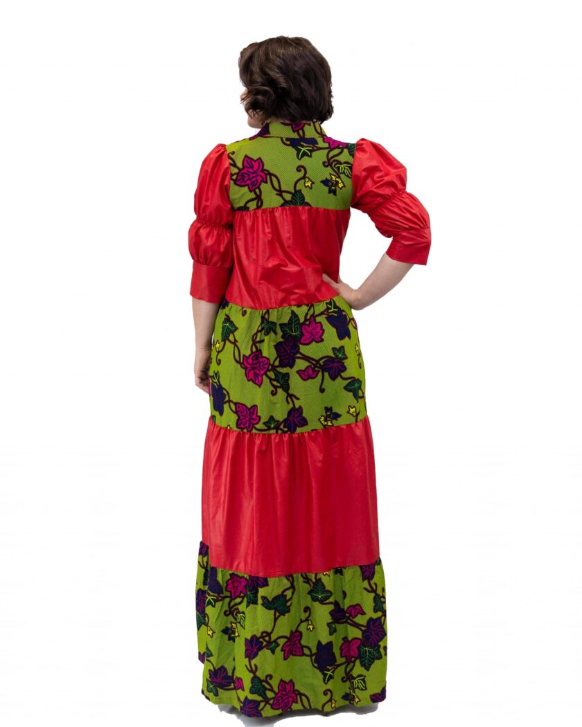 Back shot of model wearing a red and green floral African Ankara print smock maxi dress.