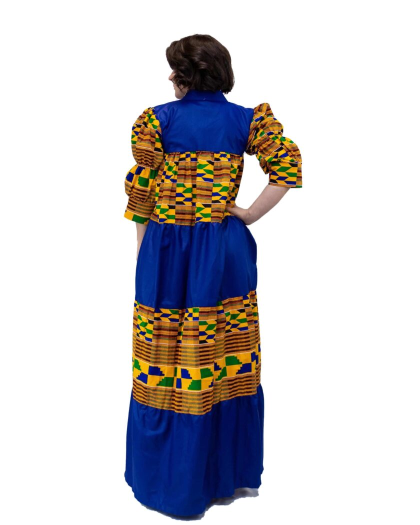 Back shot of model wearing a blue and multi-coloured African Kente print smock maxi dress.