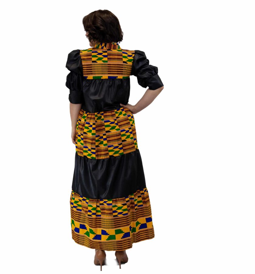 Back shot of model wearing a black and multi-coloured African Kente print smock maxi dress.
