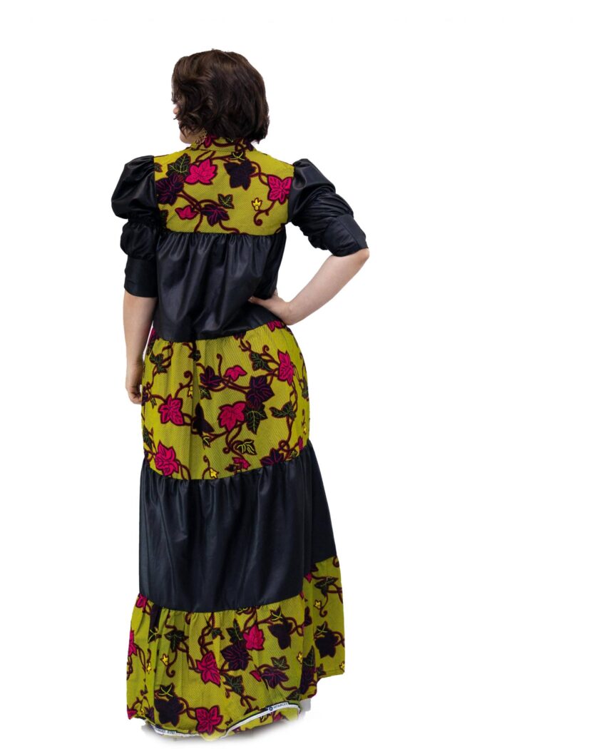 Back shot of model wearing a black and green floral African Ankara print smock maxi dress.