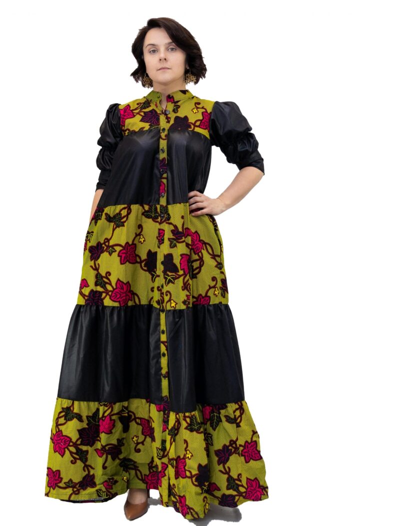Frontal of model wearing a black and green floral African Ankara print smock maxi dress.
