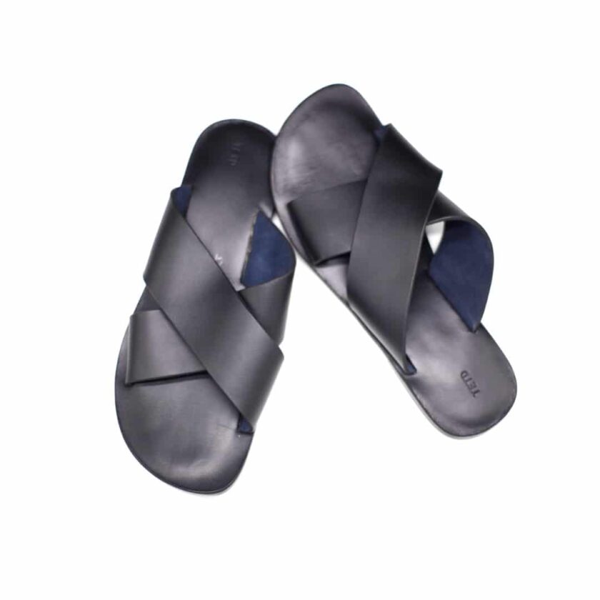 Shot of black leather men's sandals with cross strap design.