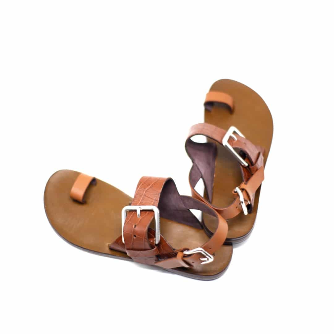 Shot of men's tan brown leather sandals with ankle strap, buckle and toe loop.