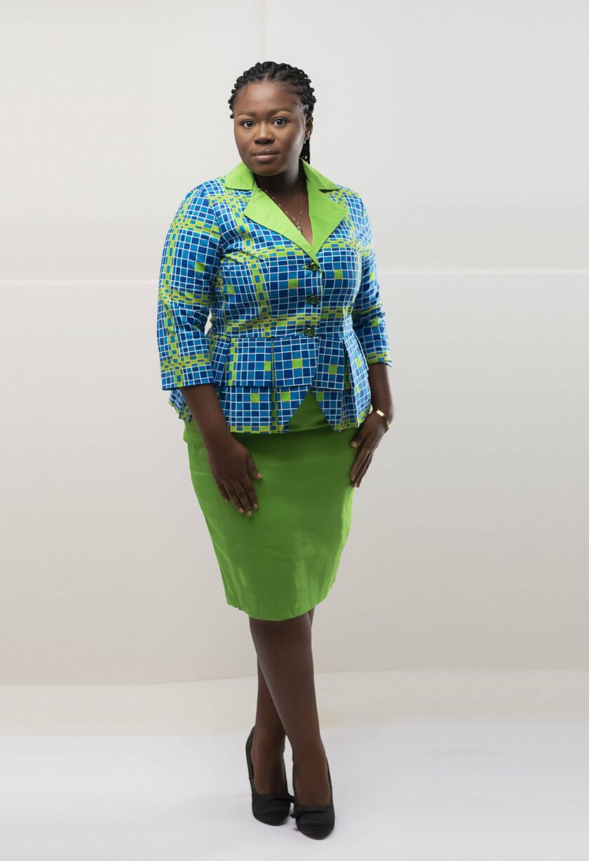 Back shot of model wearing our Nala two-piece skirt set in blue and green African print. Features a plain green pencil skirt and blue and green peplum top.