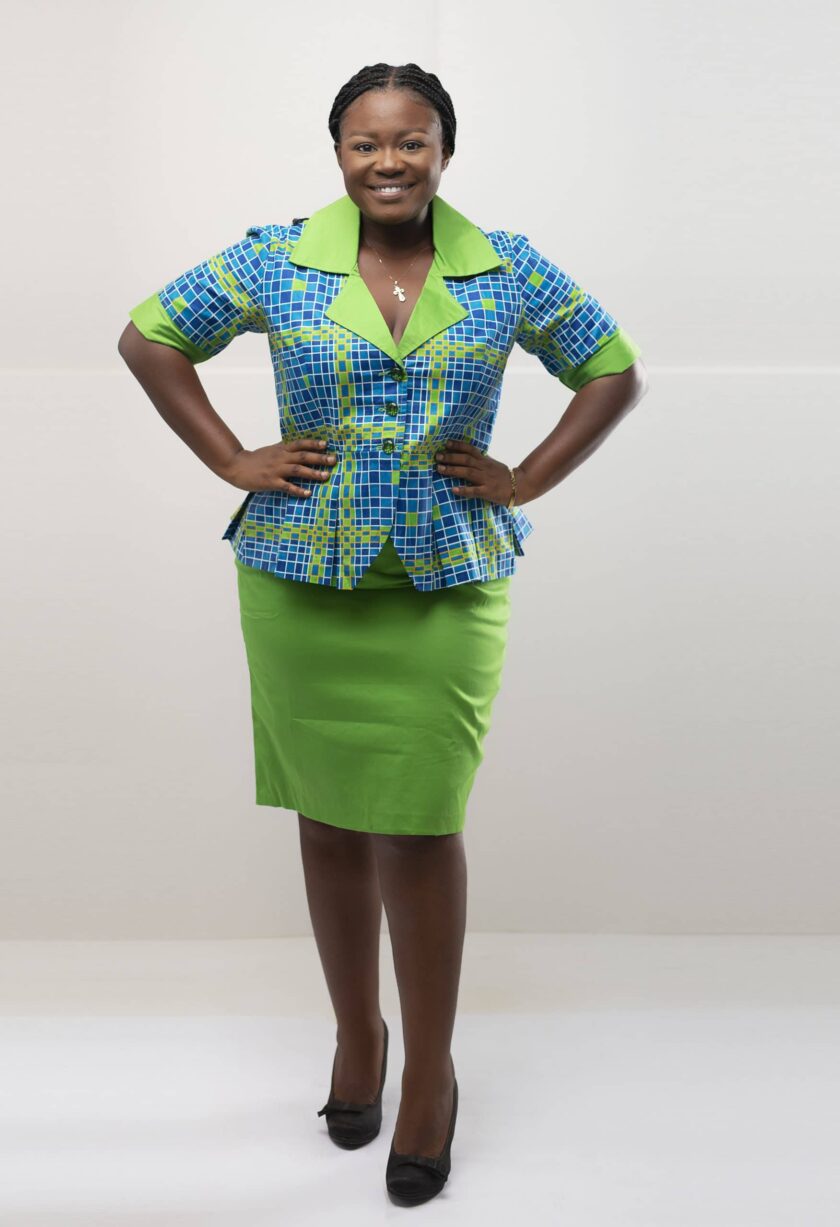 Frontal of model wearing our Nala two-piece skirt set in blue and green African print. Features a plain green pencil skirt and blue and green peplum top.