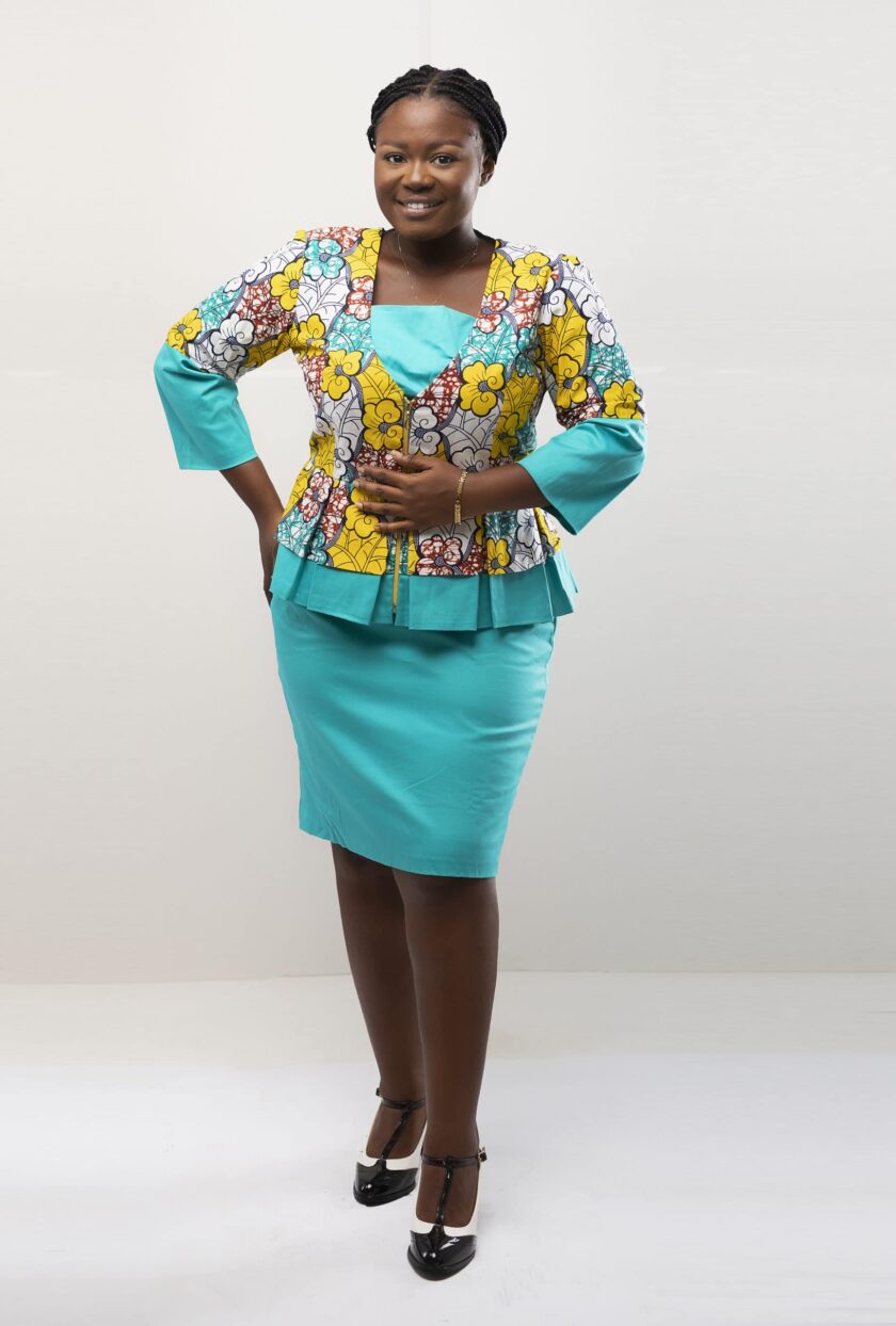 Frontal of model wearing our Angela two piece peplum top and skirt set in light blue and yellow African floral print. Features a contrasting solid light blue pencil skirt.
