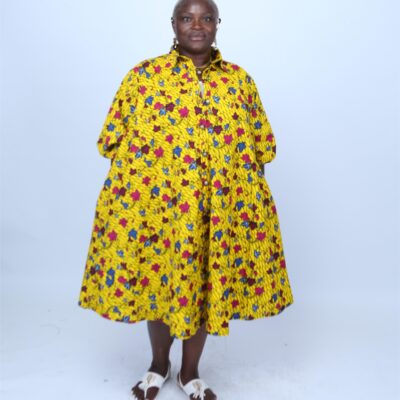 Model wearing a yellow African print dress