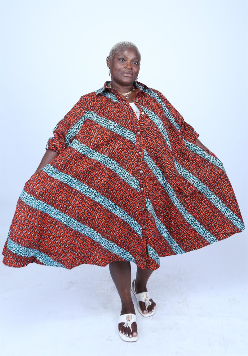 Woman wearing a orange and red striped print shirt dresss