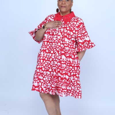 Woman posing while wearing a red and white african dress