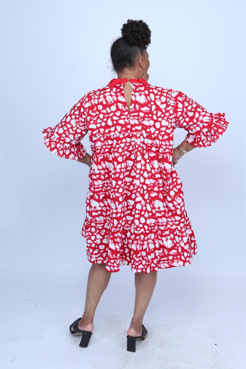 Woman showing the back of a red and white african dress